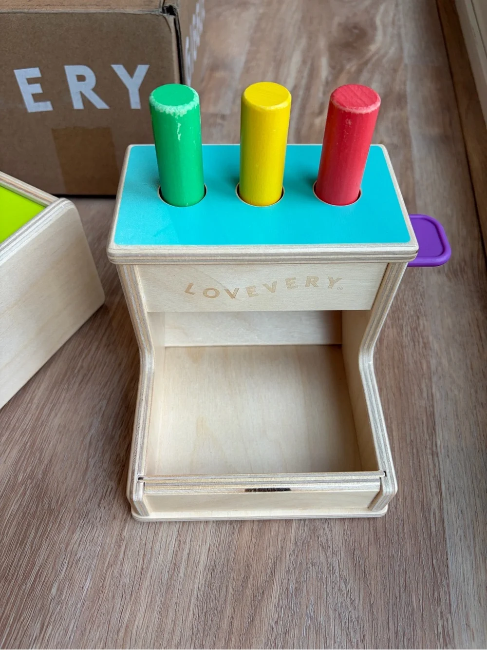 Lovevery sliding top box and wooden peg drop toys